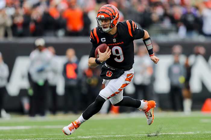 Bengals quarterback Joe Burrow runs with the ball.